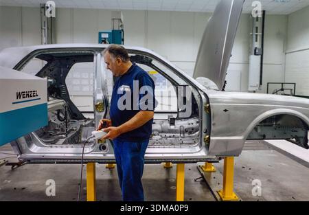 A craftsman on the assembly line with Bentley Arnage chassis at the historic Bentley factory in Crewe, England, Stock Photo