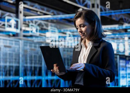 Augmented reality, laptop and programmer in server hub, optimizing equipment. Worker, data center, system architecture electronics update, VFX compositing futuristic technology concept Stock Photo