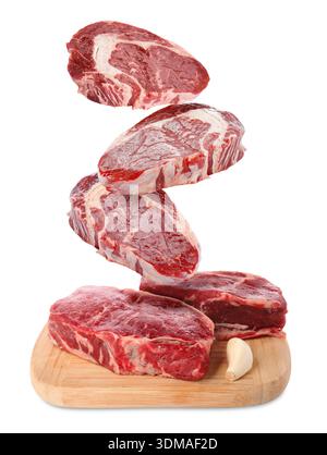 Fresh beef steaks falling on white background Stock Photo