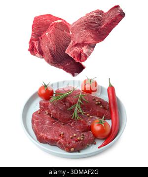 Fresh beef steaks falling on white background Stock Photo
