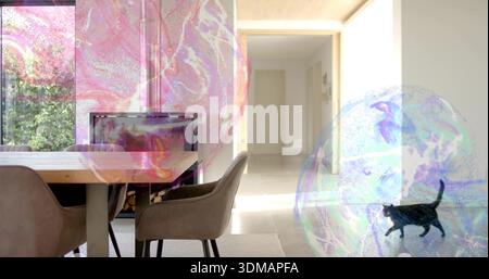 Showing wooden dining table with fabric chairs in dining area, bubbles holding cat silhouette Stock Photo