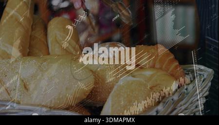 Reaching hand holding metal tongs selecting bread in bakery display, with data overlay Stock Photo