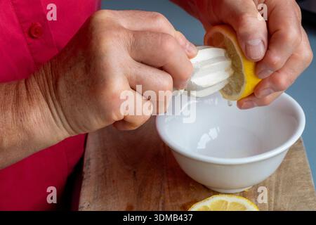Cole-up of an elderly woman's arthritic hands performing kitchen chores Stock Photo