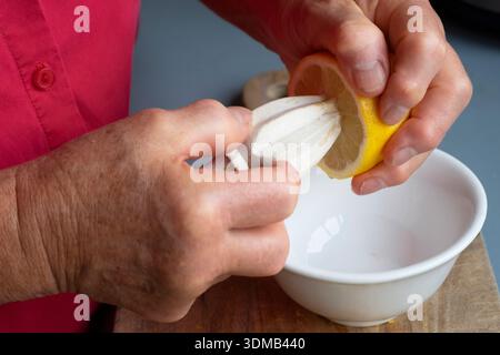 Cole-up of an elderly woman's arthritic hands performing kitchen chores Stock Photo