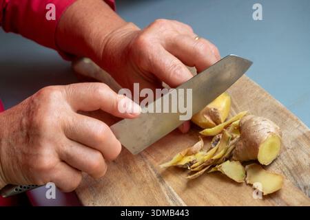 Cole-up of an elderly woman's arthritic hands performing kitchen chores Stock Photo