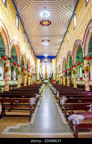 Filandia, Quindio, Colombia - December 7 2025 - Interior of a decorated church with arched windows. Stock Photo