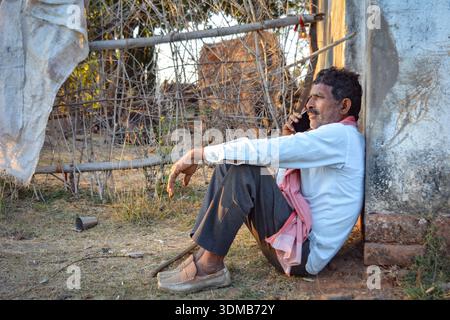 Rural indian farmer talking on mobile phone Stock Photo