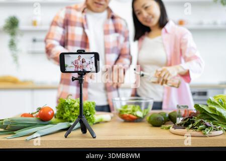 Couple Filming Cooking Video Stock Photo