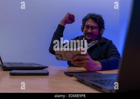 A young male gamer streams online gameplay from home, representing esports culture, digital entertainment, and content creation. Stock Photo
