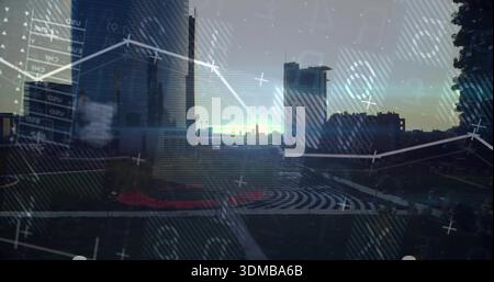 Displaying city skyline and circular plaza reflecting digital charts on glass at dusk, red planting Stock Photo