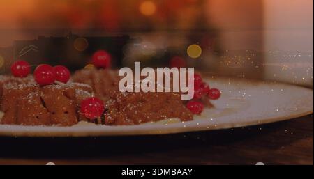 Displaying mini chocolate bundt cakes on white plate on dark wooden table, topped with red currants Stock Photo