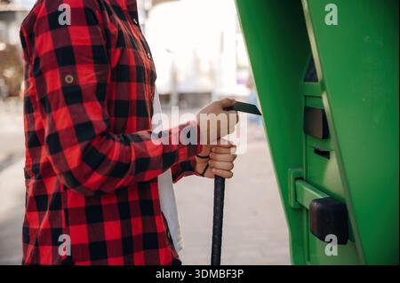 Close up view of man with white cane by the ATM using credit card. Stock Photo