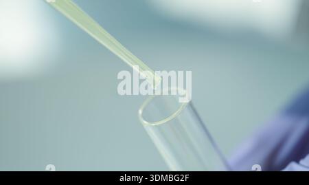 Precision in action as liquid fills test tube during scientific experimentation in a bright laboratory setting Stock Photo