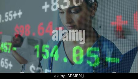 Checking nurse in blue scrubs with stethoscope using tablet at hospital bed overlaid stock numbers Stock Photo