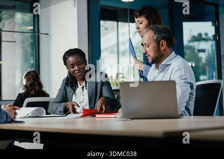 Business colleagues collaborating on project in modern office Stock Photo