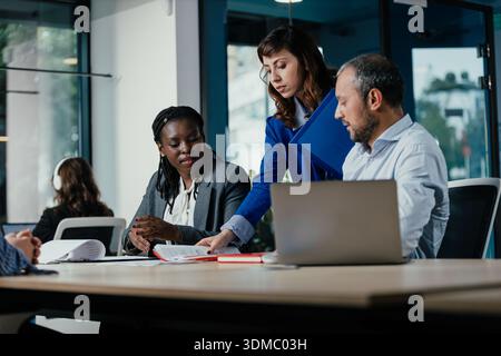 Diverse business team collaborating on project in modern office Stock Photo