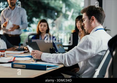 Business people collaborating during busy corporate meeting Stock Photo