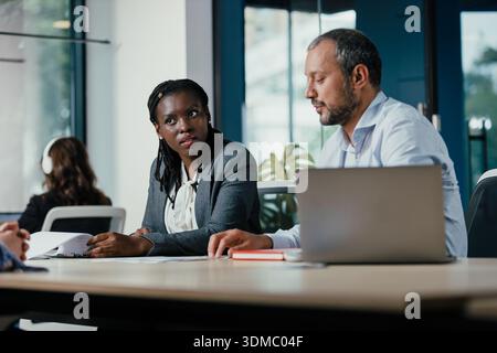 Diverse business people collaborating in modern office meeting Stock Photo