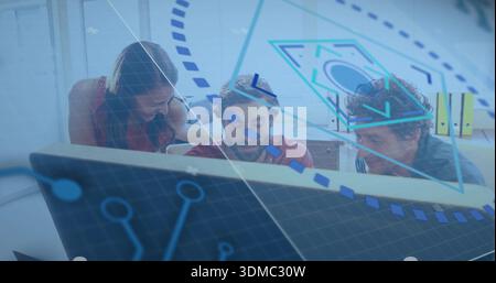 Collaborating woman in red shirt reviewing app on monitor in office, with blue overlays Stock Photo