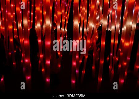 Visitors walking through illuminated light installation at Kew Gardens, London, England Stock Photo