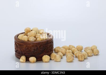 hazelnuts in a bowl on white background Stock Photo