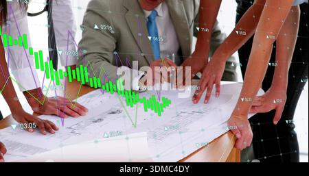 Examining team leaning over blueprint on conference table, gray suit marking with pen and charts Stock Photo