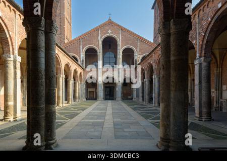 Courtyard and facade of Basilica of Saint Ambrose Basilica di SantAmbrogio Milan Italy Romanesque architecture with Ansperto atrium and brick bell tow Stock Photo