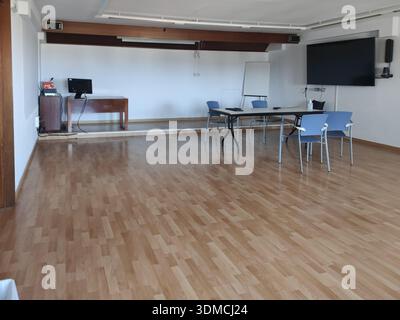 Detail of an old company meeting room, spacious room with television and projector Stock Photo