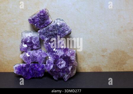 Several natural amethyst crystal clusters arranged in a vertical, balanced composition. Stock Photo