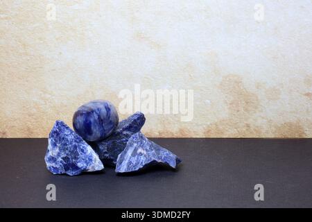 Blue Sodalite stones in both raw and polished forms, displayed together for crystal and geology visuals. Stock Photo