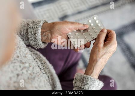 Elderly woman taking her medication at home Stock Photo