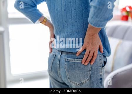 Senior woman suffering from back pain Stock Photo