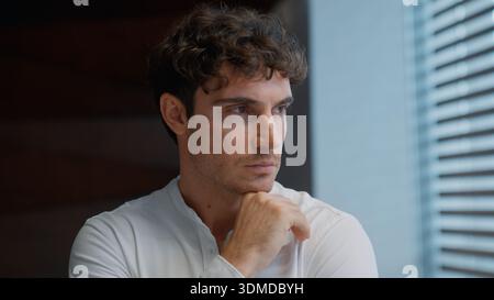 Portrait thinking Caucasian business man looking in window think contemplate puzzled hesitate businessman male guy dream executive specialist Stock Photo