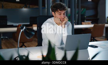 Sleepy busy tired Caucasian business man typing laptop looking in screen monitor feel fatigue businessman work computer overload overworked at table Stock Photo