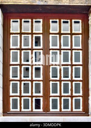 Many small windows masked with tape to prevent paint splashes on the glass panes - Tours, Indre-et-Loire (37), France. Stock Photo