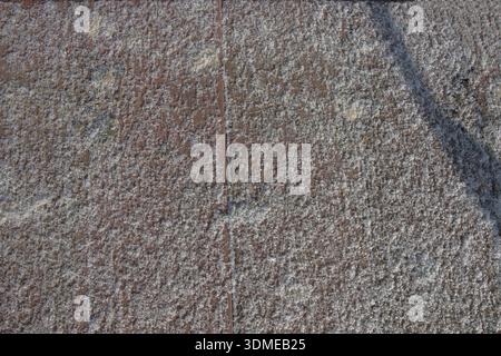 Frost covered concrete pavement texture with visible joints and rough surface Stock Photo