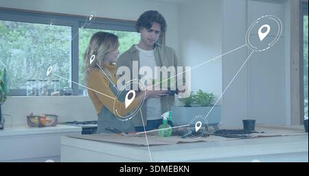 Tending two women wearing yellow sweater arranging potted herbs on island, pin overlay Stock Photo
