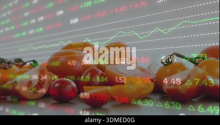 Displaying halved and cherry tomatoes on shiny counter, showing market tickers and green graph Stock Photo