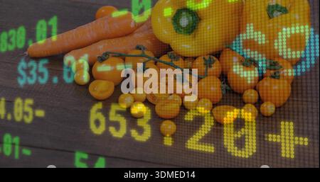 Showing orange cherry tomatoes, carrots, yellow peppers arranged on dark wood table, ticker overlay Stock Photo