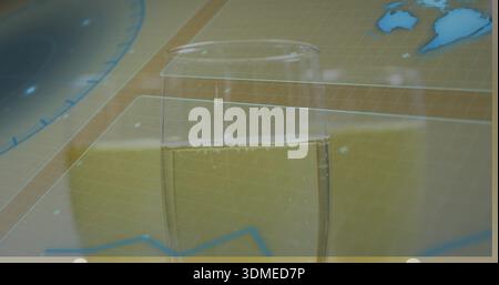 Displaying clear glass holding pale yellow sparkling liquid on wood table with map overlays Stock Photo