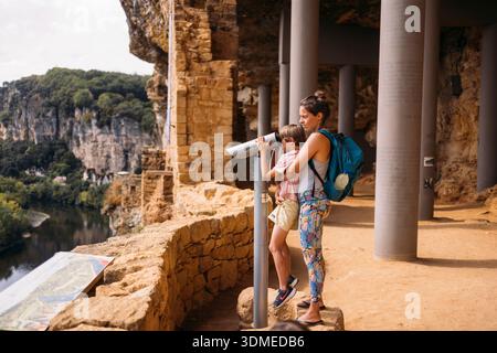La Roque-Gageac on the Dorgogne River, family outing, boy looking through a telescope Stock Photo