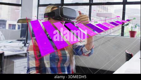 Interacting woman wearing plaid shirt adjusting holographic 3D chart at office with VR headset Stock Photo