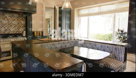 Displaying U-shaped banquette seating wrapping dark wood table in home kitchen, with pendant lights Stock Photo