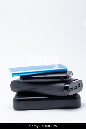 Stack of power bank battery chargers on white background Stock Photo