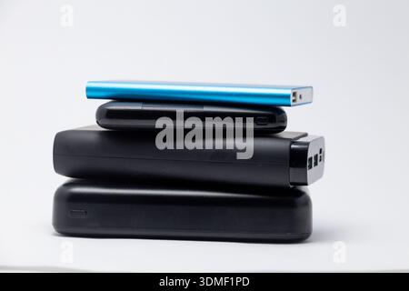 Stack of power bank battery chargers on white background Stock Photo