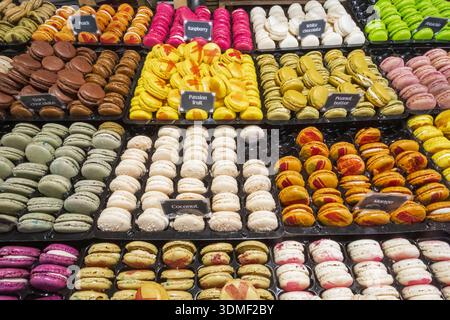 England, London, Southwark, Riverside Christmas Market, Stall Display of Colourful Macarons Stock Photo