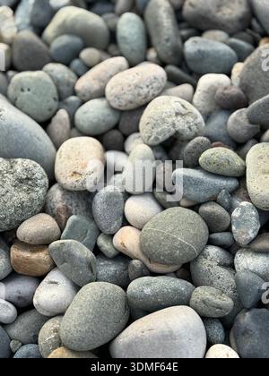 Closeup of smooth gray stones forming natural abstract background with rounded textures. Mobile photo Stock Photo