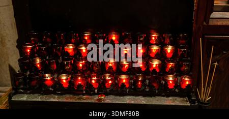 Rows of candles burning inside Trinity Church Manhattan New York Stock Photo