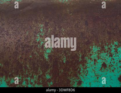 Rusty surface with exfoliated paint in turquoise using as background Stock Photo