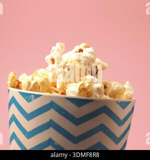 Fresh popcorn on a pink background with space for your text Stock Photo
